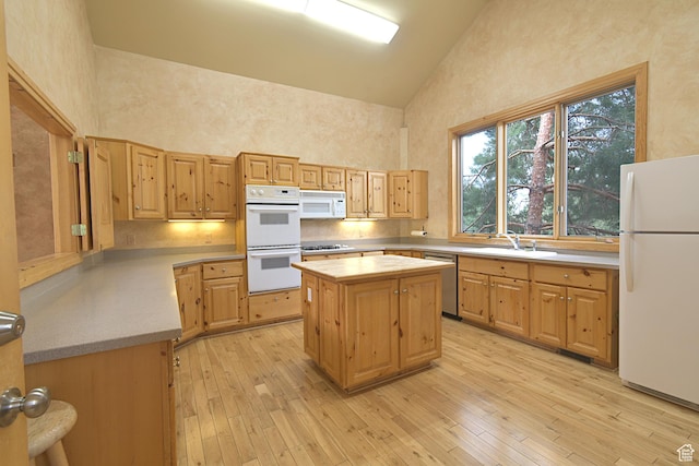 5133 N Cove Canyon Dr Unit 200, Park City, UT 84098 - kitchen featuring white appliances, high vaulted ceiling, light brown cabinetry, light wood-style floors, and a center island