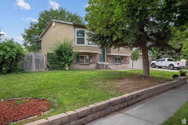 3305 W Kingsbrook Ave S Unit 148, Taylorsville, UT 84129 - view of front of house featuring stucco siding, driveway, and an attached garage
