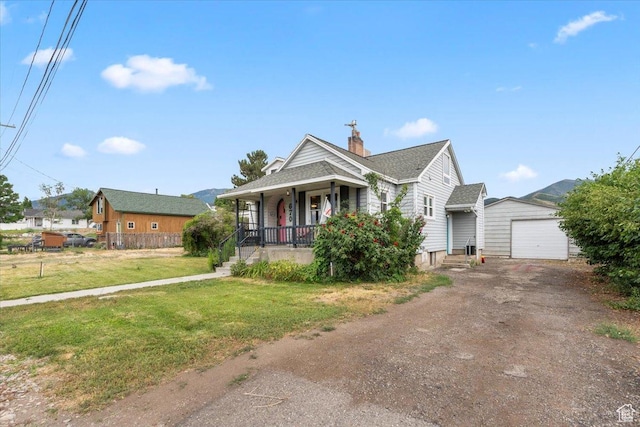 670 E 400 S, Payson, UT 84651 - bungalow featuring a porch, driveway, a front yard, an attached garage, and an outdoor structure