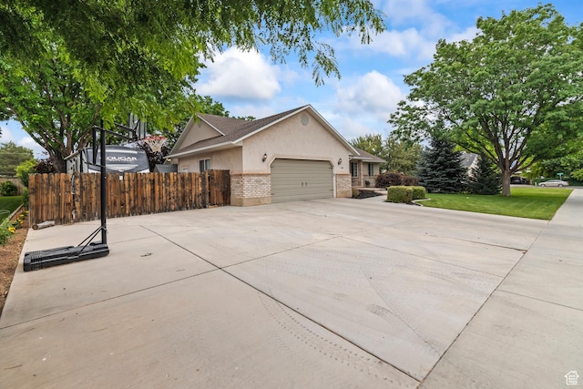 528 W 650 S, Richfield, UT 84701 - view of property exterior with stucco siding, brick siding, an attached garage, and driveway