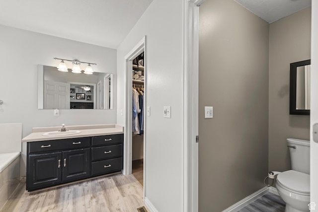 528 W 650 S, Richfield, UT 84701 - full bath featuring wood finished floors, vanity, a garden tub, and a spacious closet