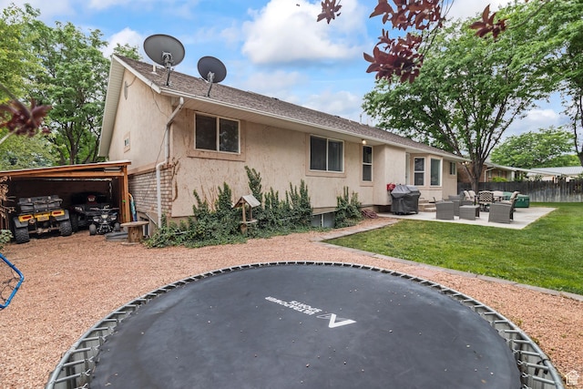 528 W 650 S, Richfield, UT 84701 - rear view of house with an outdoor living space, stucco siding, and a trampoline