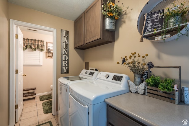 576 Mayo Dr N, Tooele, UT 84074 - laundry room featuring cabinet space, washing machine and dryer, and light tile patterned floors