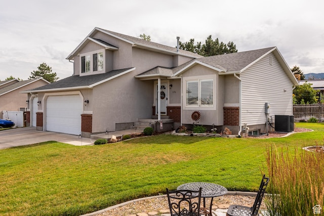 576 Mayo Dr N, Tooele, UT 84074 - view of front of house featuring a garage, driveway, stucco siding, and roof with shingles