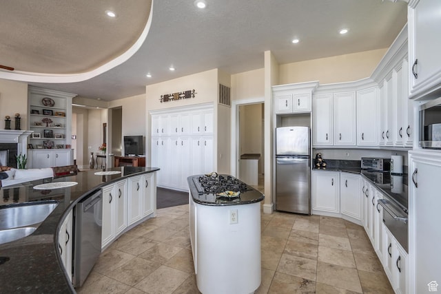 16 N Lions Head Cir, Washington, UT 84780 - kitchen featuring appliances with stainless steel finishes, white cabinets, a center island, dark stone countertops, and a warming drawer