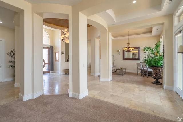 16 N Lions Head Cir, Washington, UT 84780 - foyer with a chandelier, arched walkways, a tray ceiling, light tile patterned floors, and light colored carpet