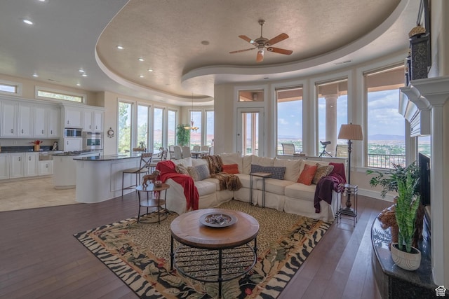 16 N Lions Head Cir, Washington, UT 84780 - living area with a tray ceiling, a ceiling fan, recessed lighting, and light wood finished floors