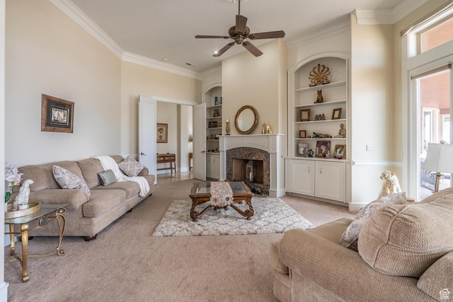 16 N Lions Head Cir, Washington, UT 84780 - living room with light carpet, a fireplace, ornamental molding, ceiling fan, and built in shelves