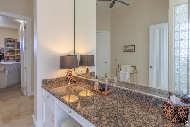 16 N Lions Head Cir, Washington, UT 84780 - kitchen with ceiling fan, dark stone counters, and white cabinets