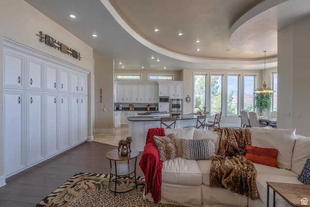 16 N Lions Head Cir, Washington, UT 84780 - living area with a tray ceiling, wood finished floors, and recessed lighting