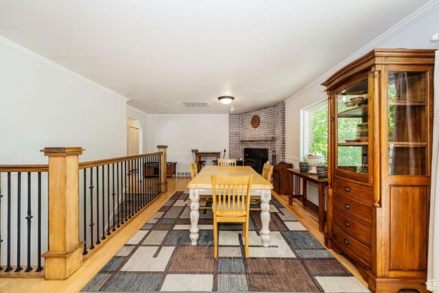 5883 S Jared Way E, South Ogden, UT 84403 - dining area featuring wood finished floors, crown molding, and a fireplace