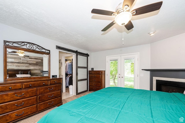 5883 S Jared Way E, South Ogden, UT 84403 - bedroom featuring french doors, access to outside, a spacious closet, a barn door, and ceiling fan