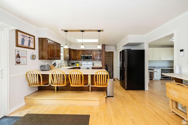 5883 S Jared Way E, South Ogden, UT 84403 - kitchen featuring stainless steel microwave, freestanding refrigerator, white electric range, a peninsula, and light wood-type flooring