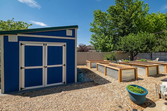 5883 S Jared Way E, South Ogden, UT 84403 - view of shed with a garden and a fenced backyard
