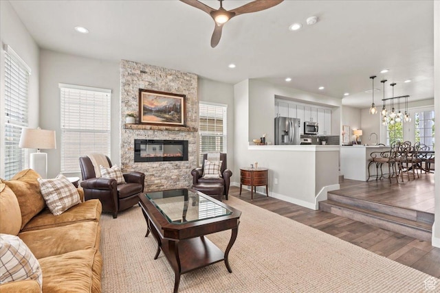 5328 W S Jordan Pkwy S, South Jordan, UT 84009 - living area with light wood finished floors, ceiling fan, a stone fireplace, and recessed lighting