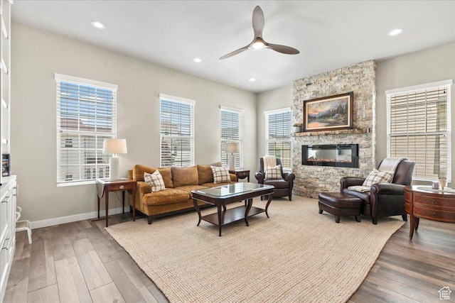 5328 W S Jordan Pkwy S, South Jordan, UT 84009 - living room with ceiling fan, light wood-type flooring, a stone fireplace, and recessed lighting