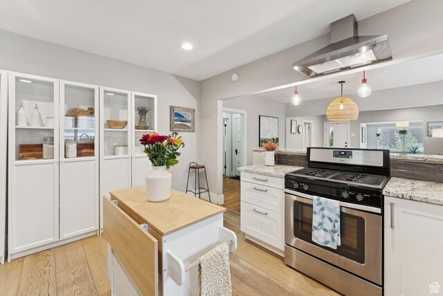 1873 S Lincoln St E, Salt Lake City, UT 84105 - kitchen with stainless steel gas range, wall chimney range hood, white cabinets, light wood-style flooring, and recessed lighting