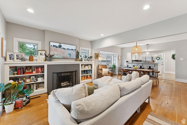 1873 S Lincoln St E, Salt Lake City, UT 84105 - living area with light wood-type flooring, a brick fireplace, and recessed lighting