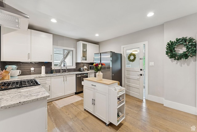 1873 S Lincoln St E, Salt Lake City, UT 84105 - kitchen with appliances with stainless steel finishes, backsplash, light wood-style flooring, open shelves, and white cabinets