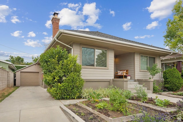 1873 S Lincoln St E, Salt Lake City, UT 84105 - view of front of property with concrete driveway, a garden, a chimney, and a garage
