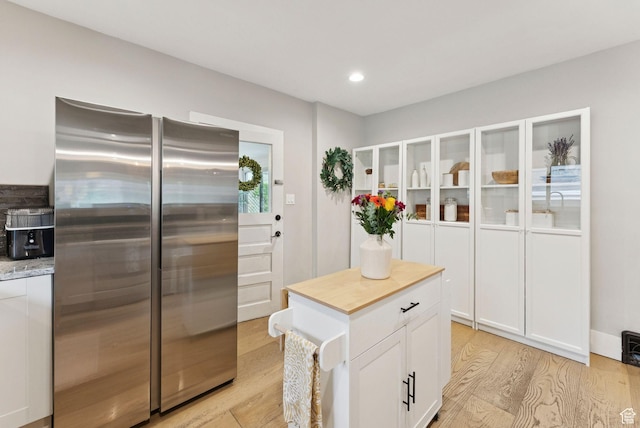 1873 S Lincoln St E, Salt Lake City, UT 84105 - kitchen featuring stainless steel fridge, light wood-style floors, white cabinetry, wooden counters, and recessed lighting