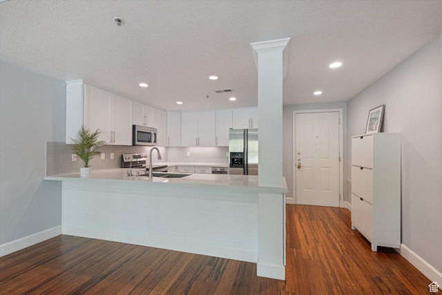 3075 E Kennedy Dr Unit 315, Salt Lake City, UT 84108 - kitchen featuring stainless steel appliances, a peninsula, light countertops, dark wood finished floors, and recessed lighting