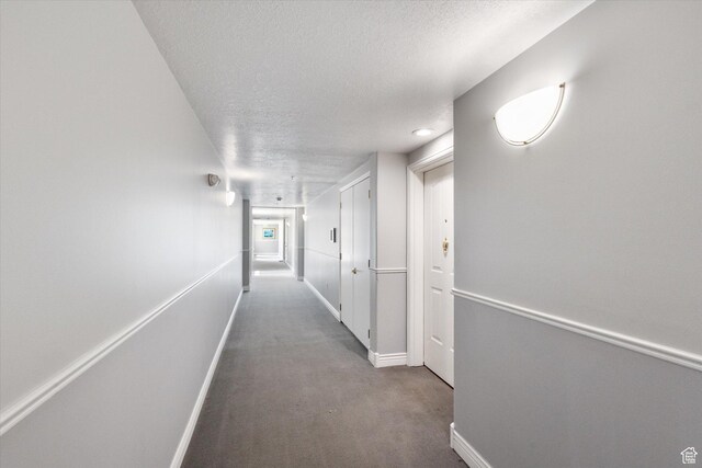 3075 E Kennedy Dr Unit 315, Salt Lake City, UT 84108 - corridor featuring a textured ceiling and carpet