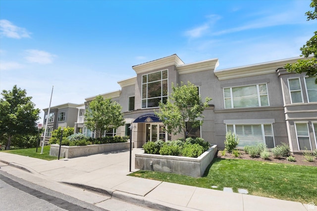 3075 E Kennedy Dr Unit 315, Salt Lake City, UT 84108 - view of front of house featuring stucco siding and a front lawn