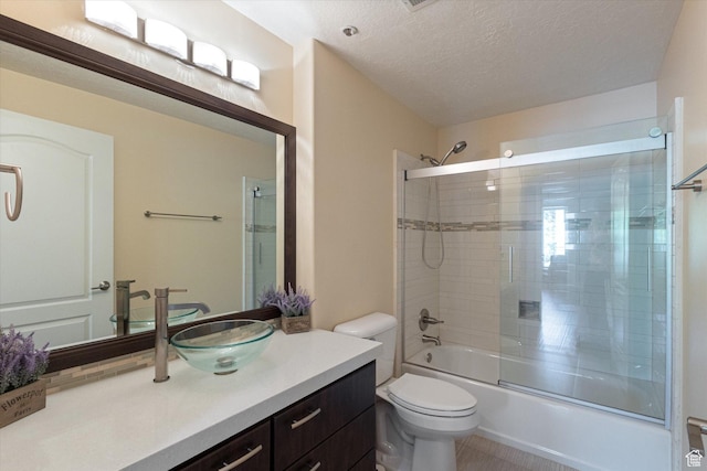 3075 E Kennedy Dr Unit 315, Salt Lake City, UT 84108 - full bathroom with vanity, combined bath / shower with glass door, and a textured ceiling