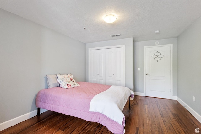3075 E Kennedy Dr Unit 315, Salt Lake City, UT 84108 - bedroom featuring wood finished floors, a closet, and a textured ceiling
