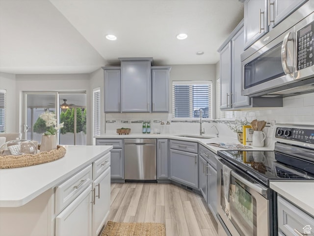 2296 S 2040 W, Woods Cross, UT 84087 - kitchen with stainless steel appliances, gray cabinets, light countertops, decorative backsplash, and recessed lighting
