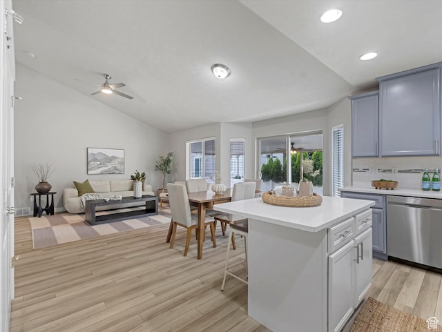 2296 S 2040 W, Woods Cross, UT 84087 - kitchen with dishwasher, lofted ceiling, light countertops, light wood finished floors, and decorative backsplash