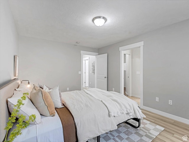 2296 S 2040 W, Woods Cross, UT 84087 - bedroom featuring light wood finished floors and a textured ceiling