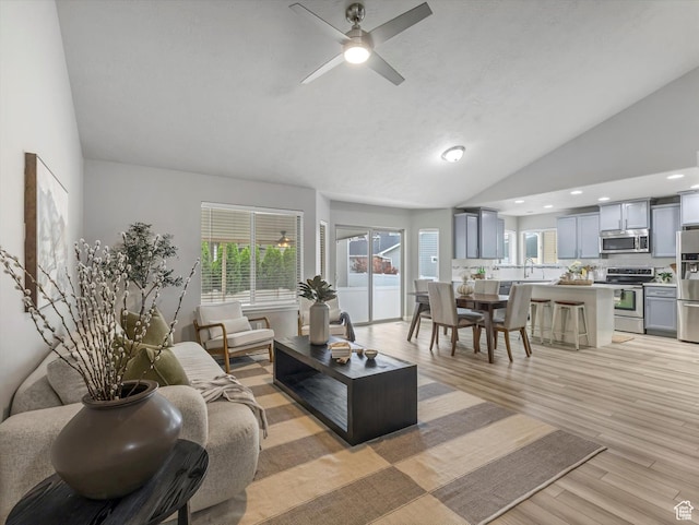 2296 S 2040 W, Woods Cross, UT 84087 - living area featuring light wood finished floors, a ceiling fan, recessed lighting, and high vaulted ceiling