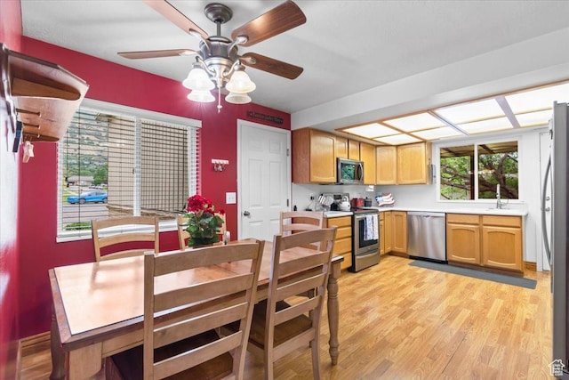 388 S Golden Circle Dr E, Fruit Heights, UT 84037 - kitchen featuring appliances with stainless steel finishes, ceiling fan, light countertops, and light wood-style floors