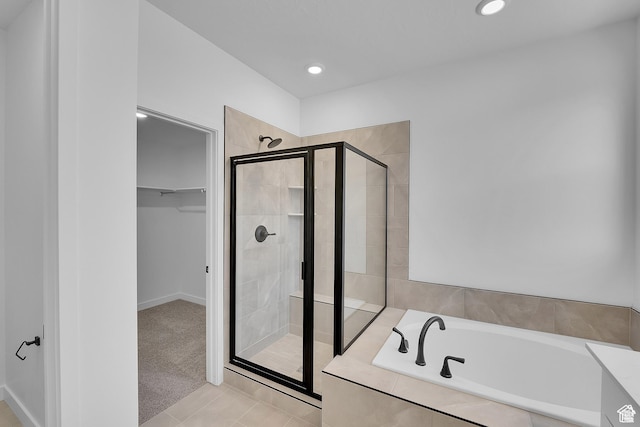 1089 S 3170 E Unit 205, Spanish Fork, UT 84660 - full bathroom featuring a shower stall, a garden tub, a walk in closet, recessed lighting, and tile patterned flooring