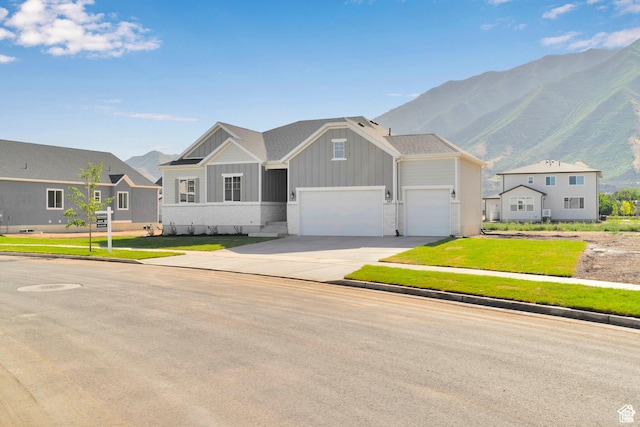 1147 S 3170 E Unit 207, Spanish Fork, UT 84660 - craftsman inspired home with board and batten siding, a mountain view, concrete driveway, a front yard, and a garage