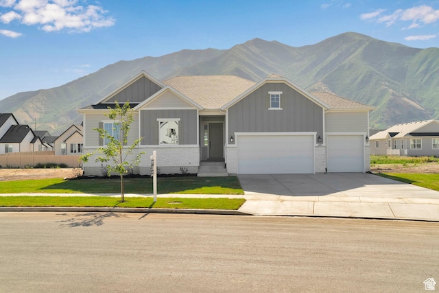 1147 S 3170 E Unit 207, Spanish Fork, UT 84660 - craftsman house featuring board and batten siding, a mountain view, concrete driveway, an attached garage, and a front lawn