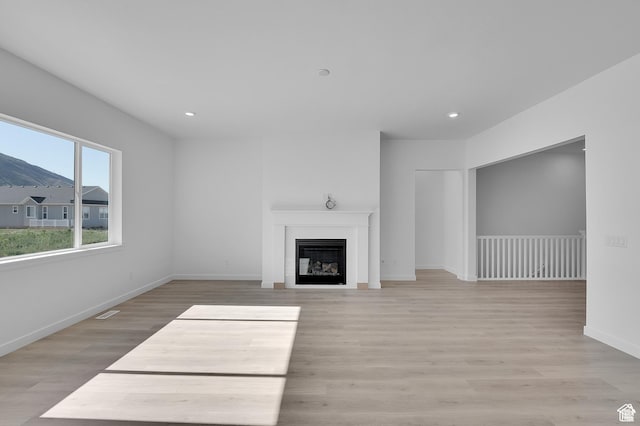 1147 S 3170 E Unit 207, Spanish Fork, UT 84660 - unfurnished living room featuring light wood finished floors, a fireplace, and recessed lighting