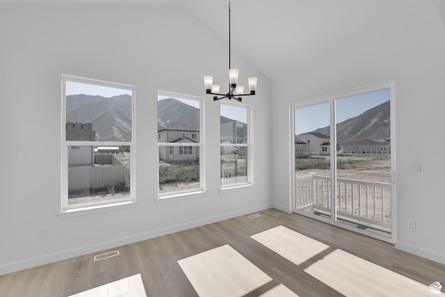 1147 S 3170 E Unit 207, Spanish Fork, UT 84660 - unfurnished dining area featuring a chandelier, wood finished floors, high vaulted ceiling, and a mountain view
