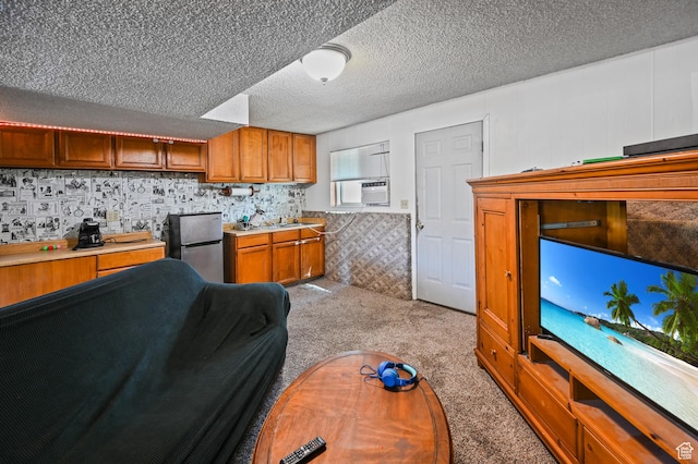 308 W 1050 N, Logan, UT 84321 - kitchen featuring freestanding refrigerator, light carpet, light countertops, brown cabinets, and a textured ceiling