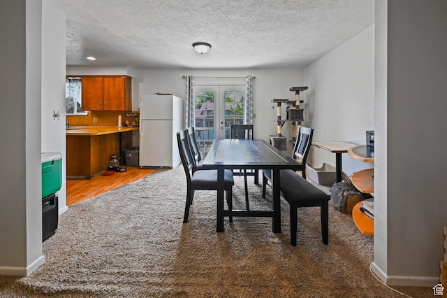 308 W 1050 N, Logan, UT 84321 - carpeted dining room featuring french doors, a textured ceiling, and wood finished floors