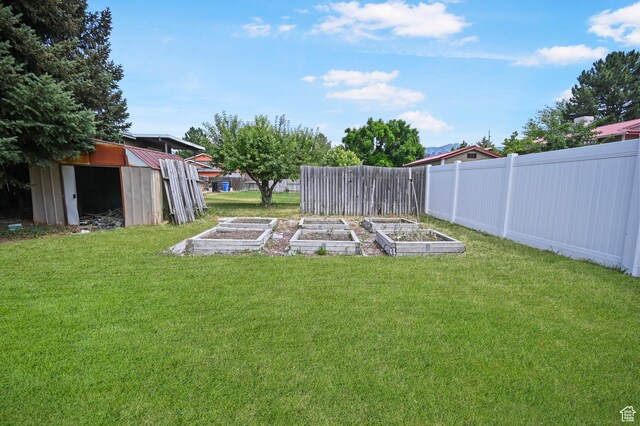 308 W 1050 N, Logan, UT 84321 - view of yard featuring a garden and a shed