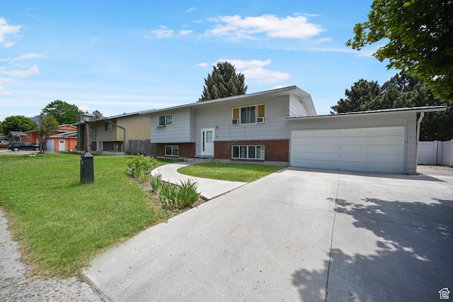 308 W 1050 N, Logan, UT 84321 - bi-level home with concrete driveway, an attached garage, and brick siding