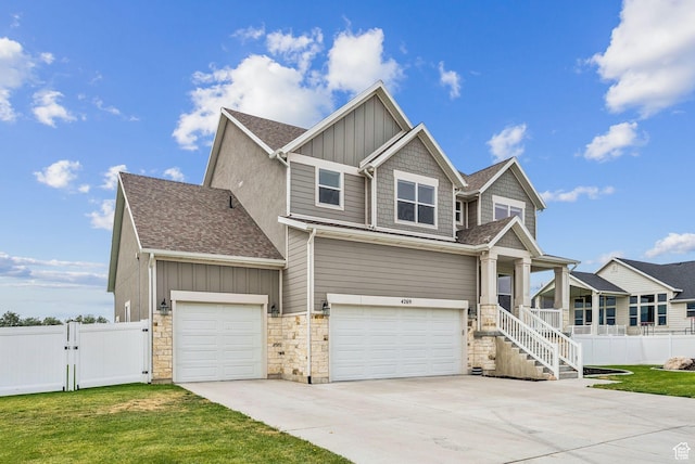 4269 W 2025 S, West Haven, UT 84401 - craftsman house with board and batten siding, driveway, a garage, stone siding, and a gate
