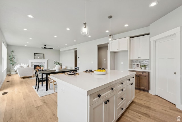 4269 W 2025 S, West Haven, UT 84401 - kitchen featuring ceiling fan, light wood finished floors, recessed lighting, open floor plan, and a stone fireplace