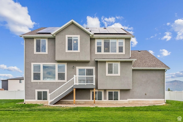 4269 W 2025 S, West Haven, UT 84401 - back of property featuring stairs, roof mounted solar panels, stucco siding, a wooden deck, and roof with shingles