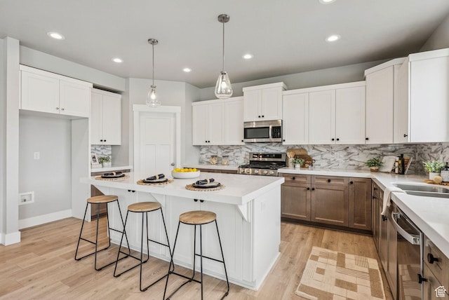 4269 W 2025 S, West Haven, UT 84401 - kitchen featuring appliances with stainless steel finishes, tasteful backsplash, a center island, light countertops, and recessed lighting