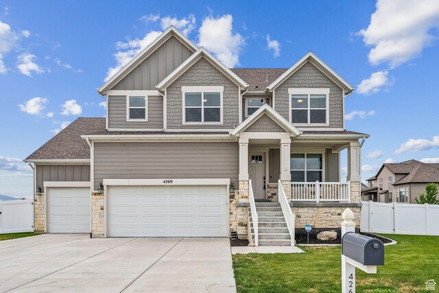4269 W 2025 S, West Haven, UT 84401 - craftsman inspired home with covered porch, driveway, stone siding, and an attached garage