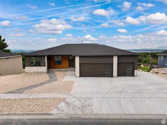 3071 N Mountain Rd Unit 4, North Ogden, UT 84414 - view of front of house featuring an attached garage, driveway, stone siding, and covered porch